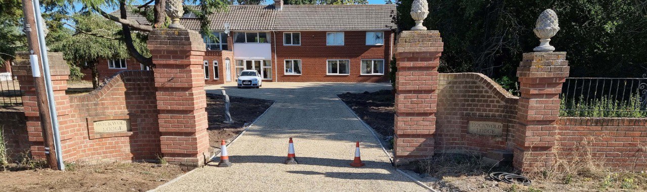 This is a photo of a newly installed chip and tar driveway, installed by Long Buckby Driveways